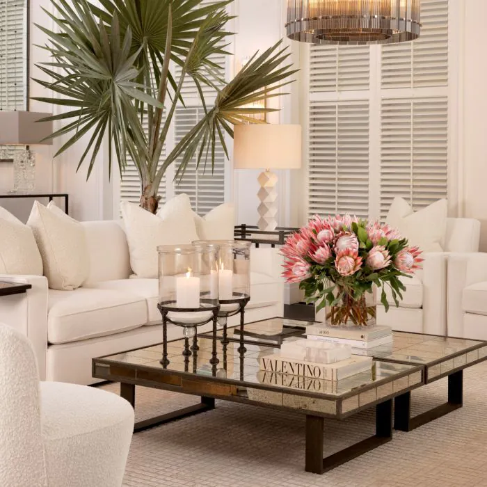 white eichholtz sofa with white pillows